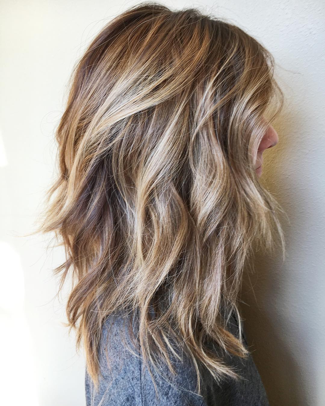Textured Mid-Length Layered Cut with Soft Waves