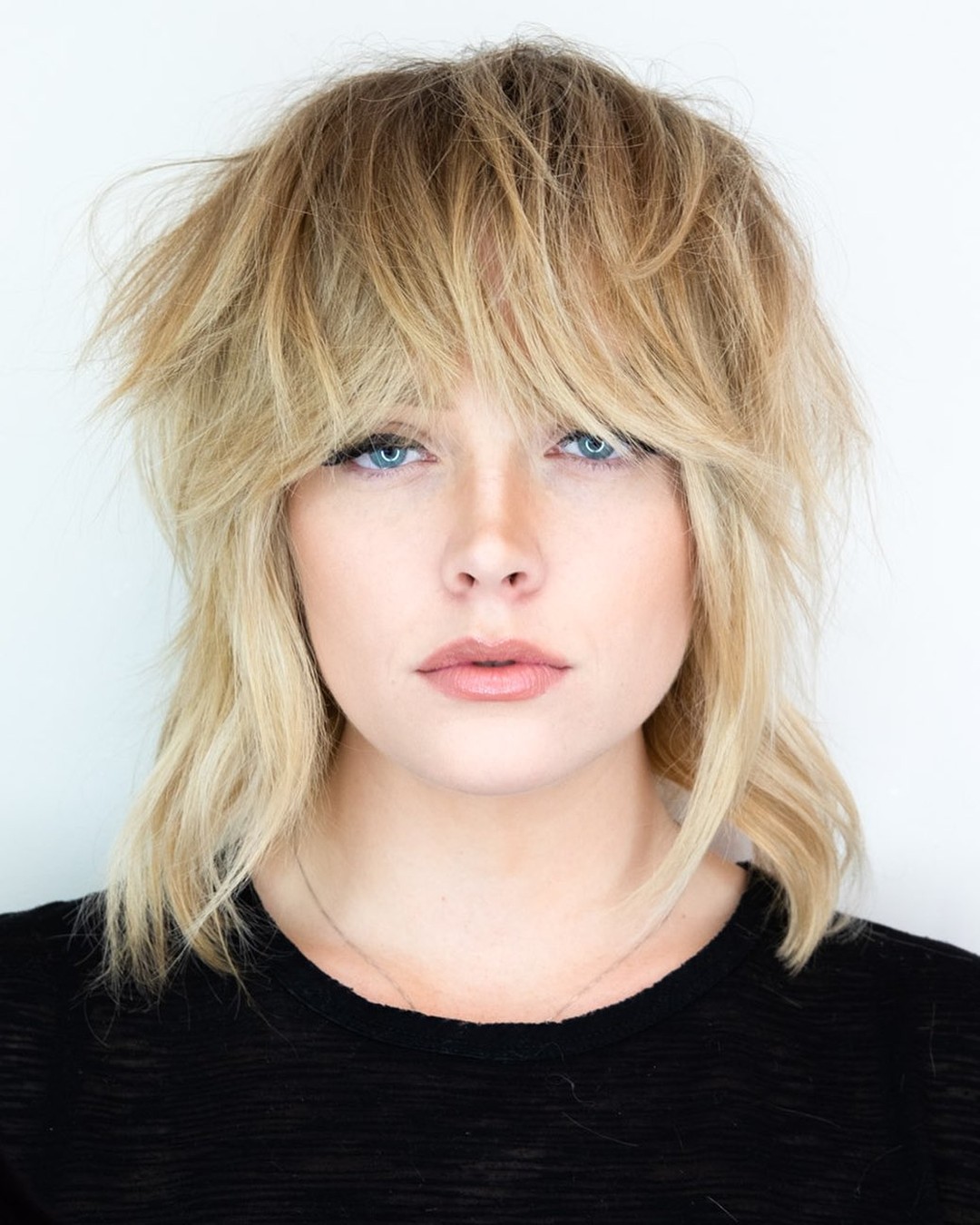 Textured Feathered Wolf Cut with Soft Blonde Highlights