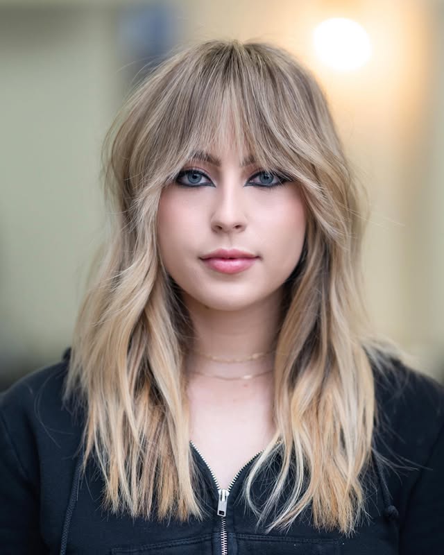 Trendy Layered Cut with Wispy Bangs and Subtle Ombre