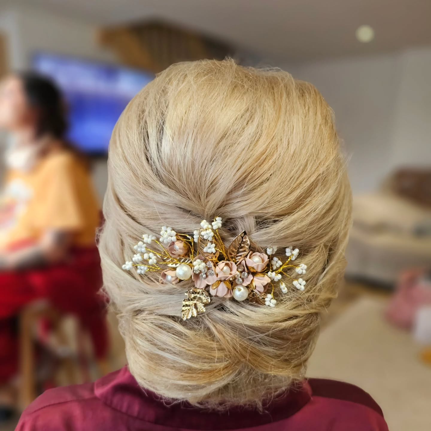 Elegant Textured Low Bun with Floral Accents