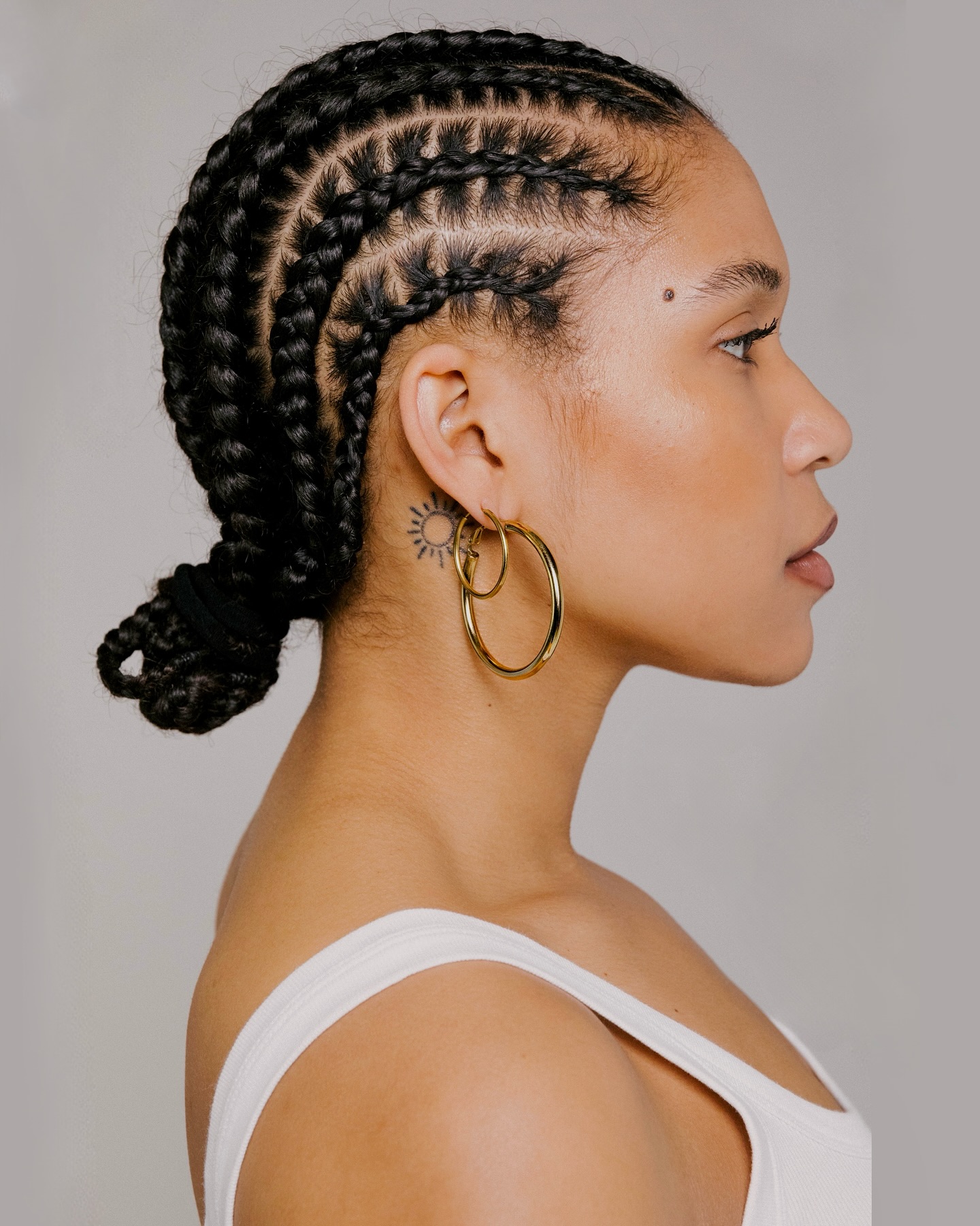 Intricate Cornrow Braids with Low Bun