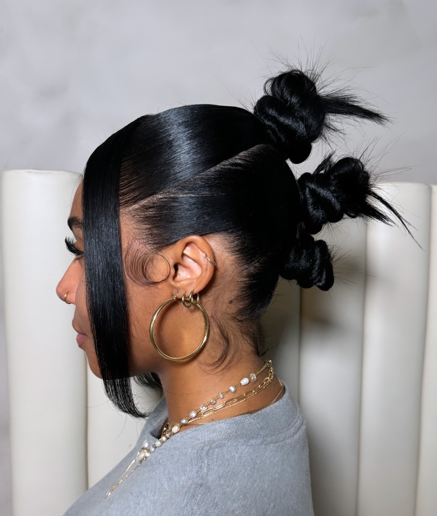 Sleek High Buns with Edgy Side Part