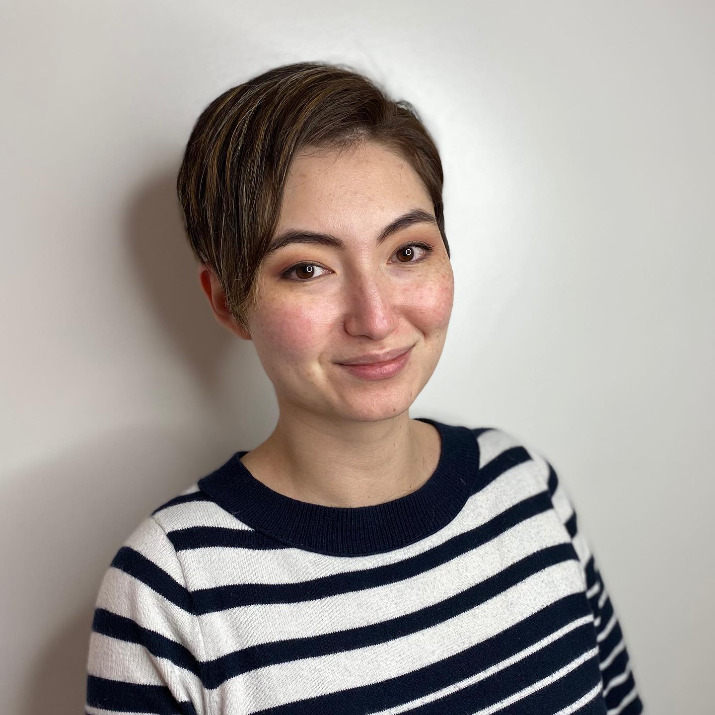 Stylish Asymmetrical Pixie Cut with Subtle Caramel Highlights