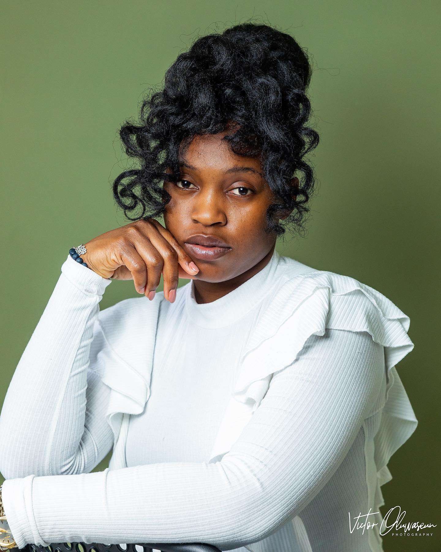 Voluminous Curly High Bun with Defined Curls