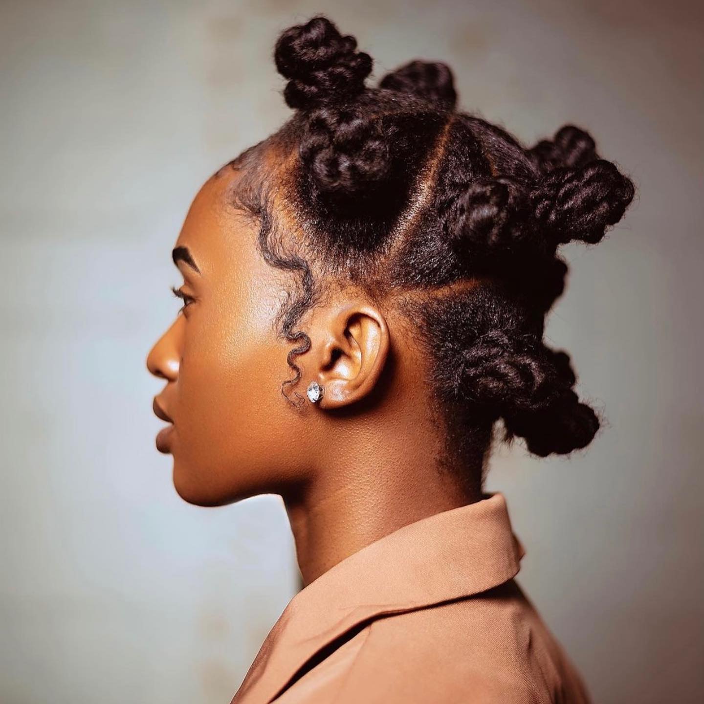 Chic Defined Bantu Knots with Subtle Curls