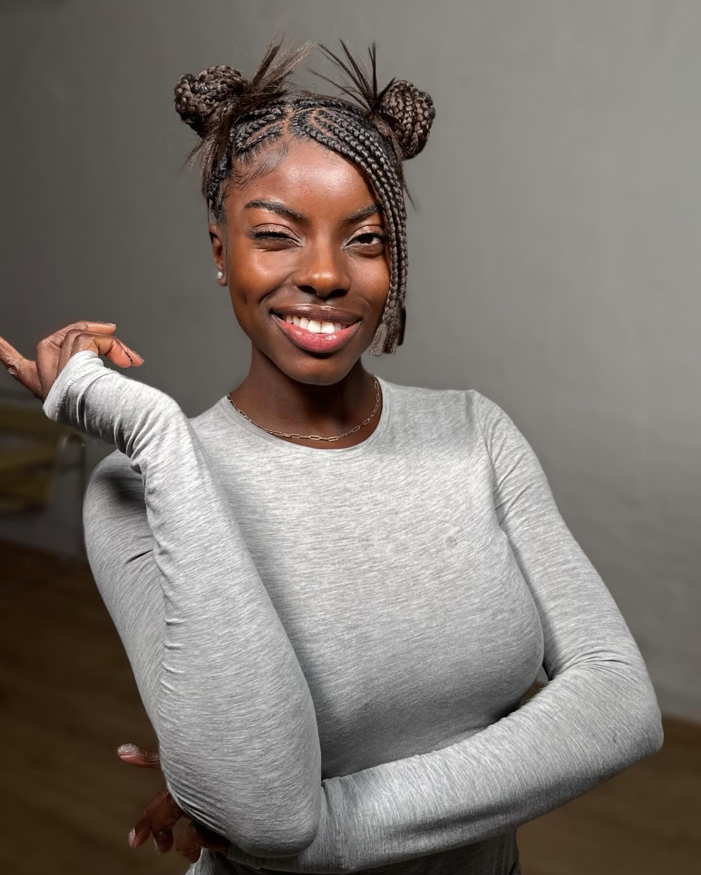 Chic Braided Coily Space Buns with Textured Accents