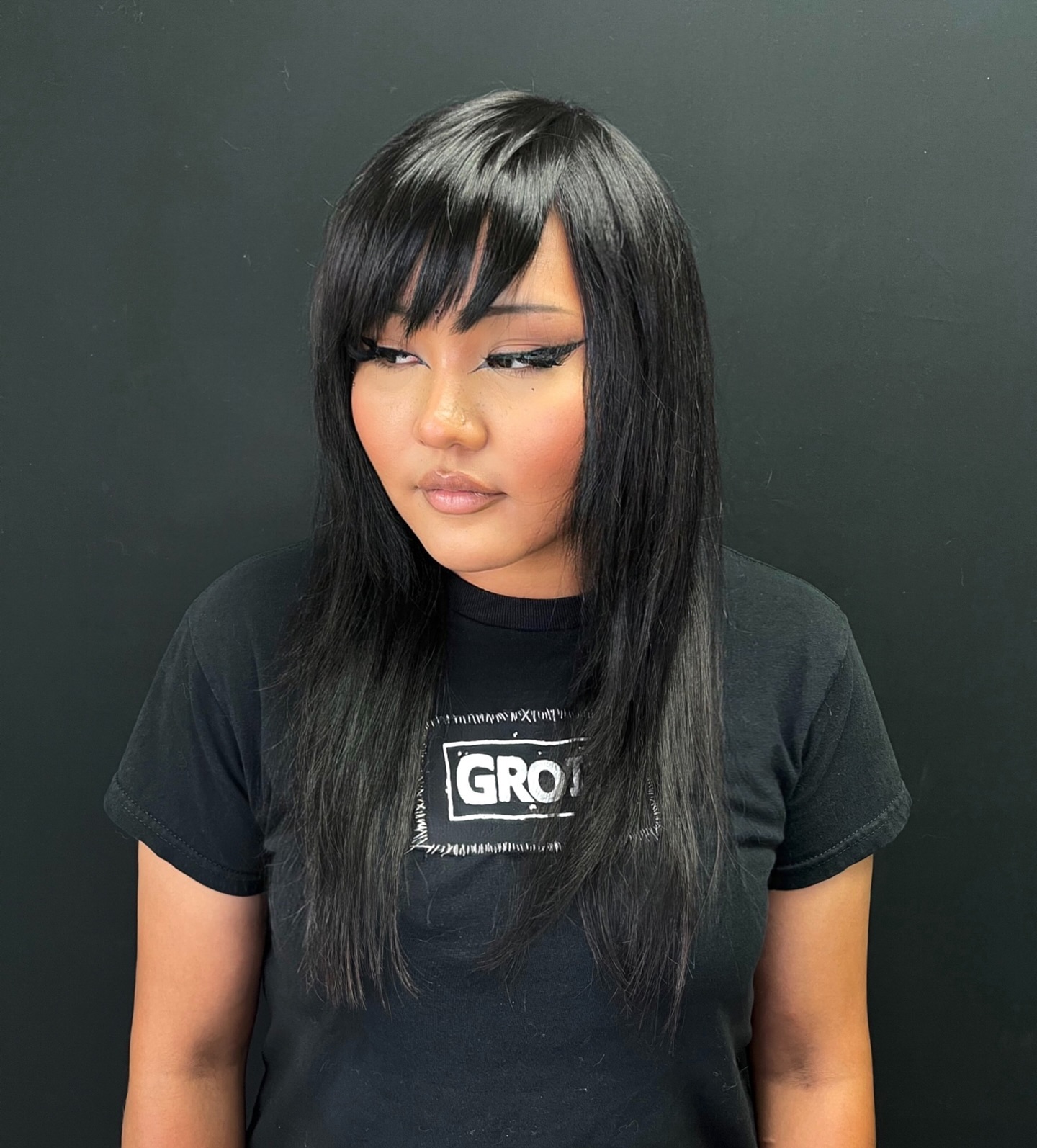 Layered Black Haircut with Bold Side Bangs