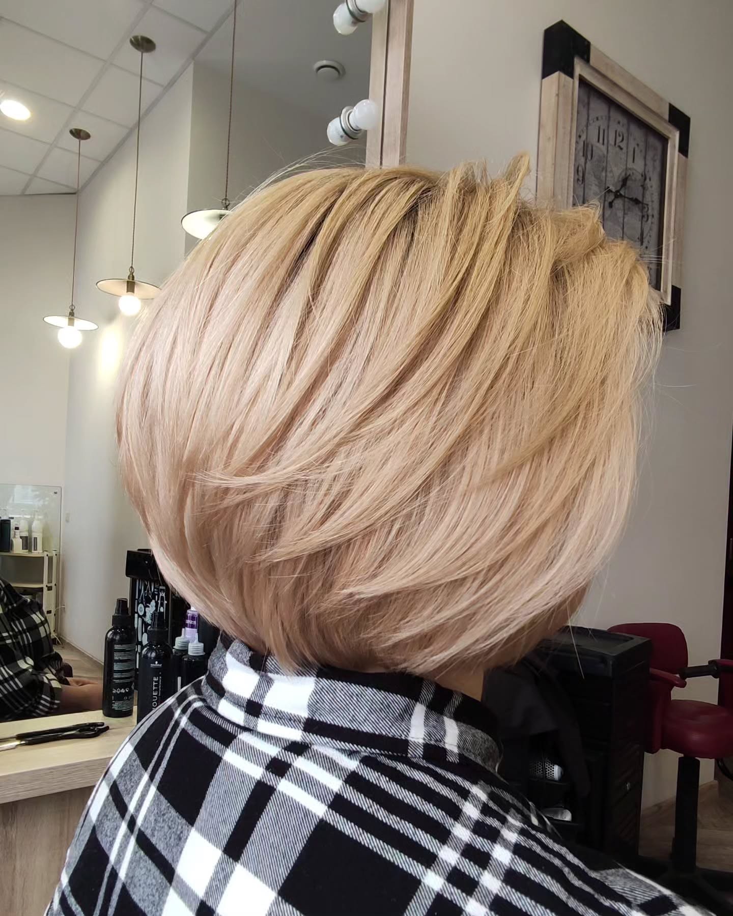 Stylish Asymmetrical Feathered Bob with Soft Blonde Highlights