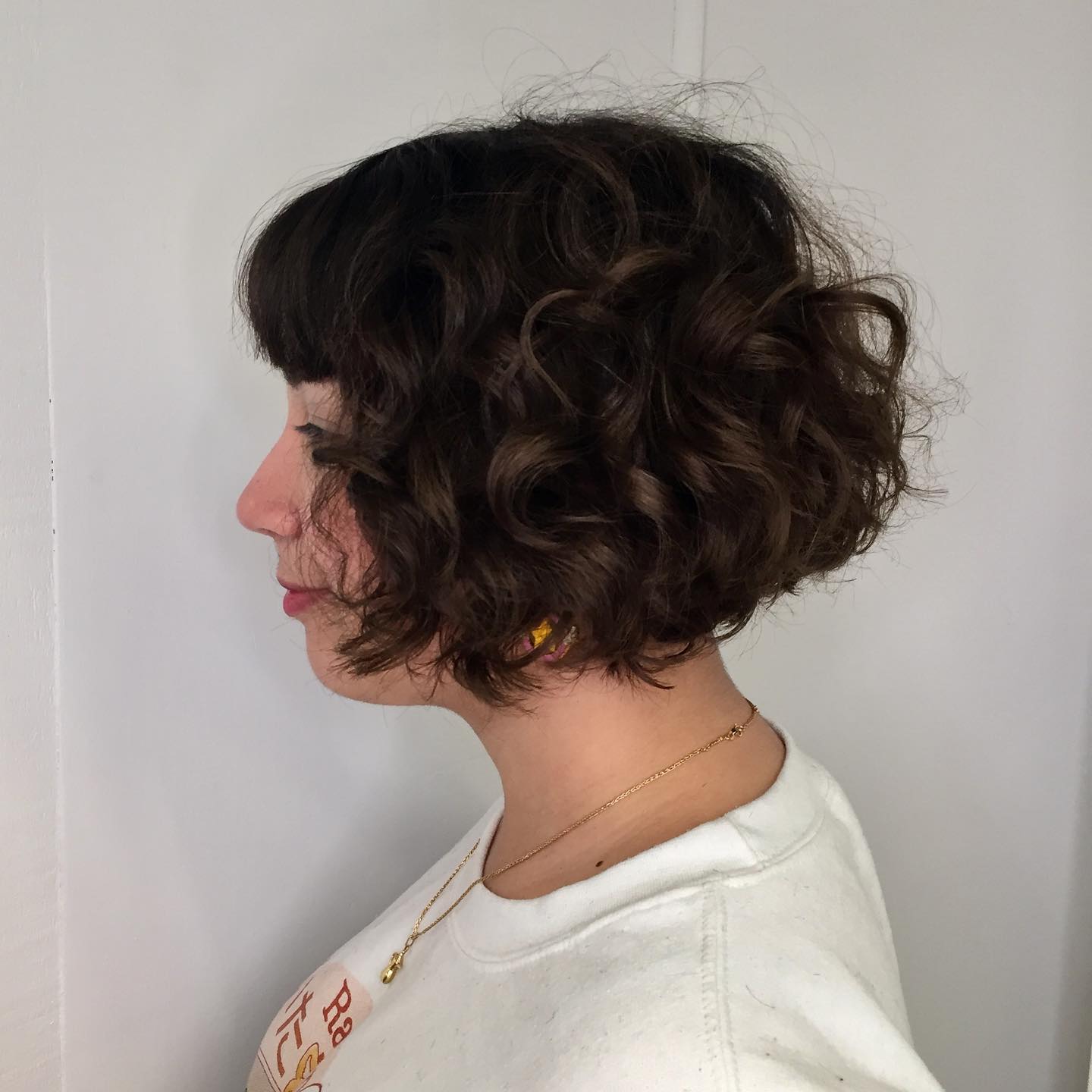 Textured Jaw-Length Curly Bob with Full Bangs