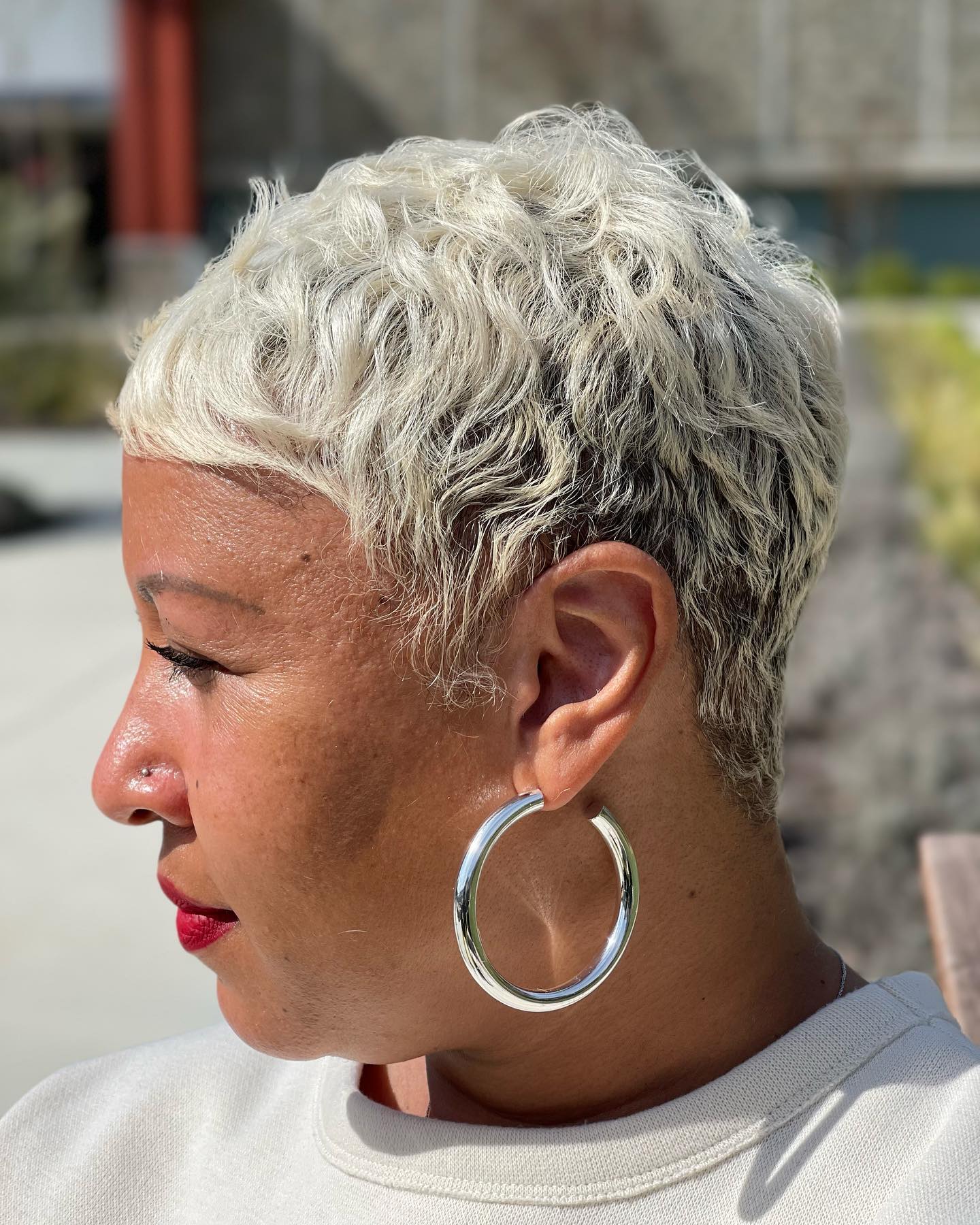 Textured Short Curly Cut with Soft Platinum Highlights