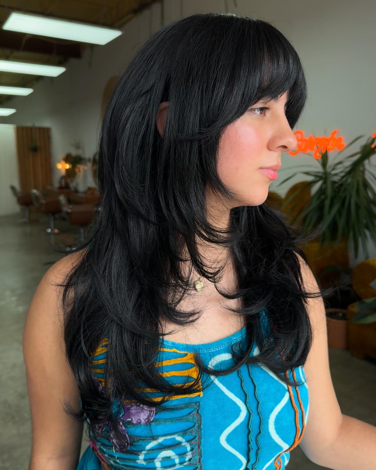 chic long layered cut with soft bangs