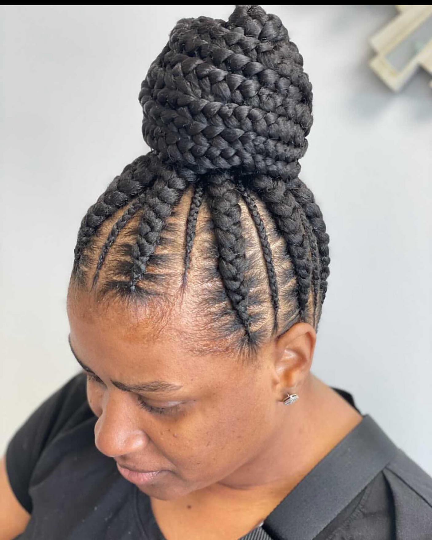 Elegant High Braided Bun with Intricate Cornrow Detailing