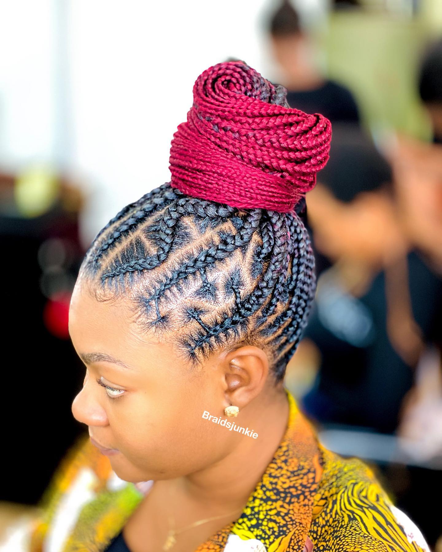 Elegant Twisted Braided Bun with Burgundy Accents