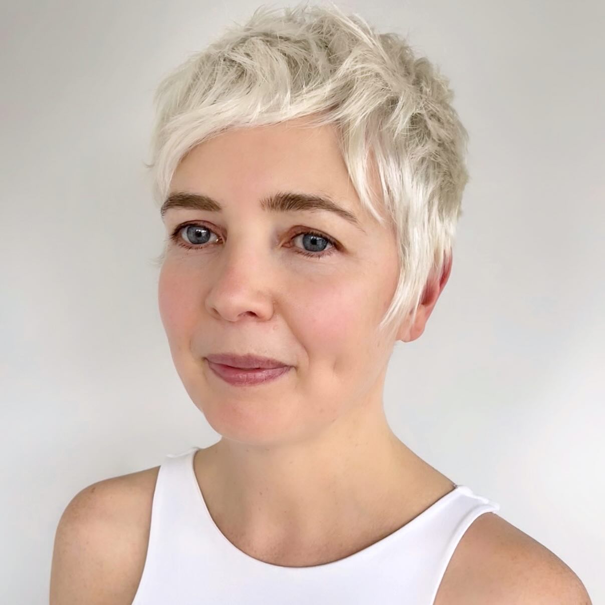 chic textured short haircut with soft blonde highlights
