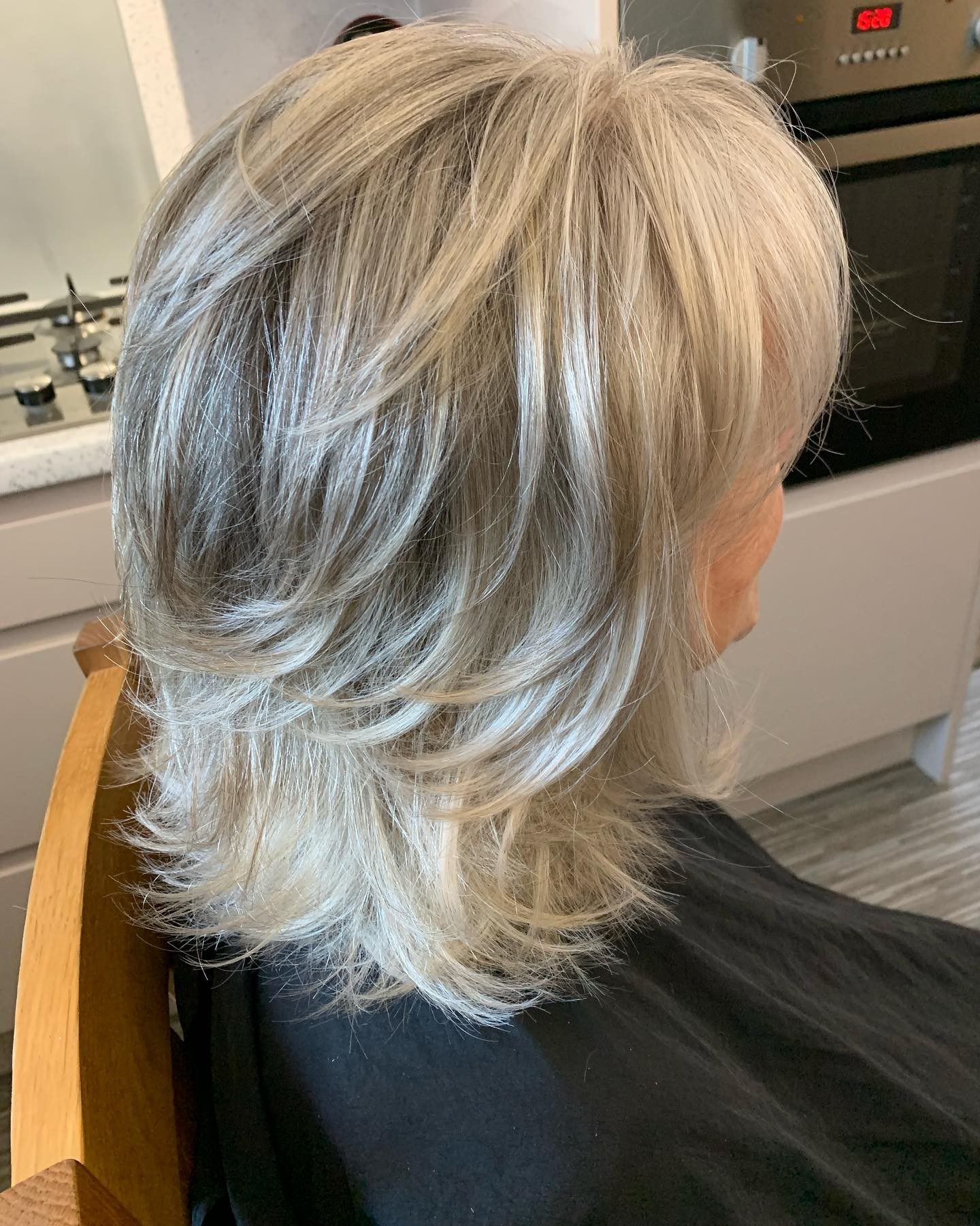 Dynamic Layered Shoulder-Length Cut with Silvery Highlights