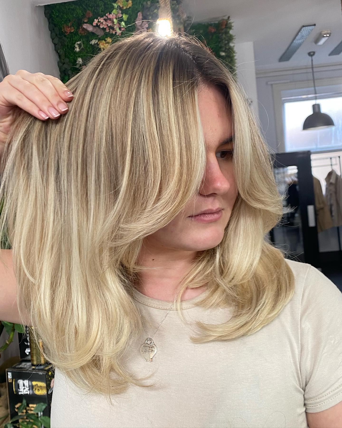 Elegant Blonde Layered Cut with Face-Frame Highlights