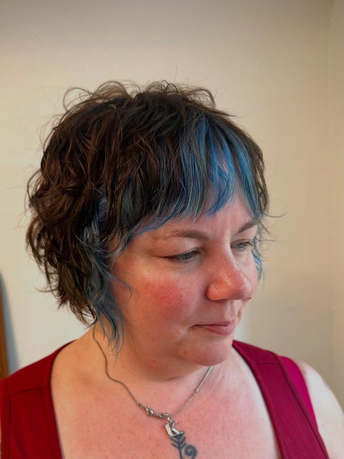 Textured Tousled Pixie Bob with Vibrant Blue Highlights