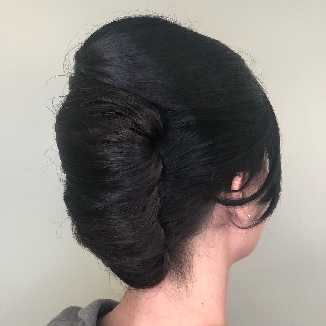 Elegant Textured Low Chignon with Face-Framing Tendrils