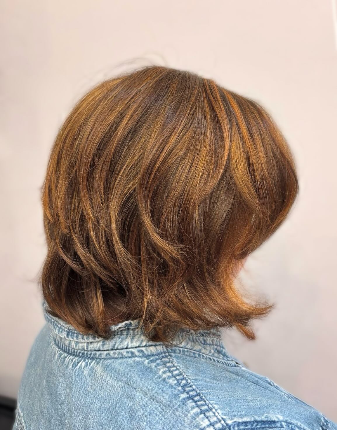 Textured Shoulder-Length Cut with Warm Auburn Highlights