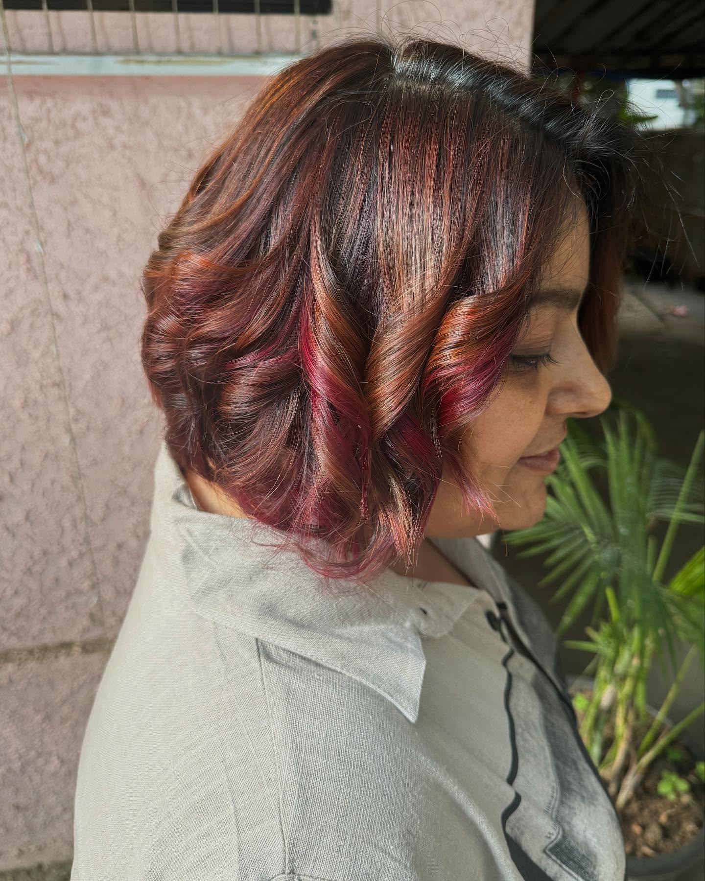 Vibrant Curly Bob with Burgundy Highlights