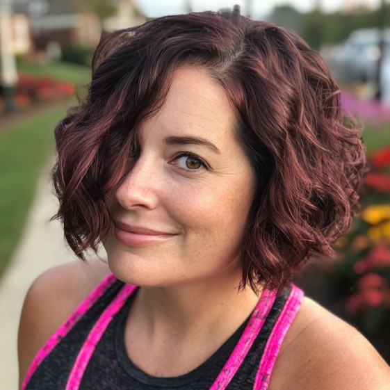 Chic Textured Curly Bob with Deep Plum Highlights