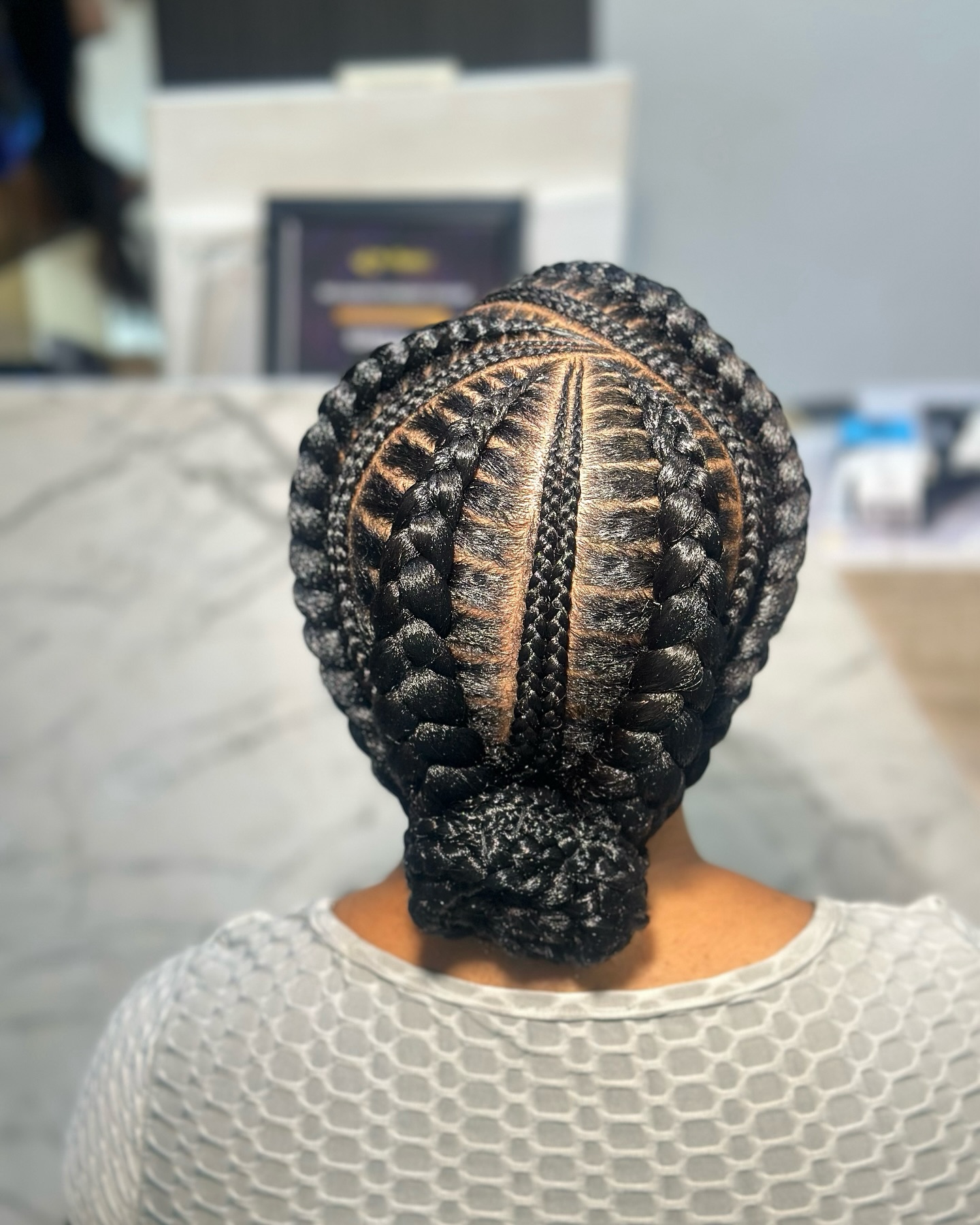 Intricate Feed-in Braids with a Chic Bun Finish