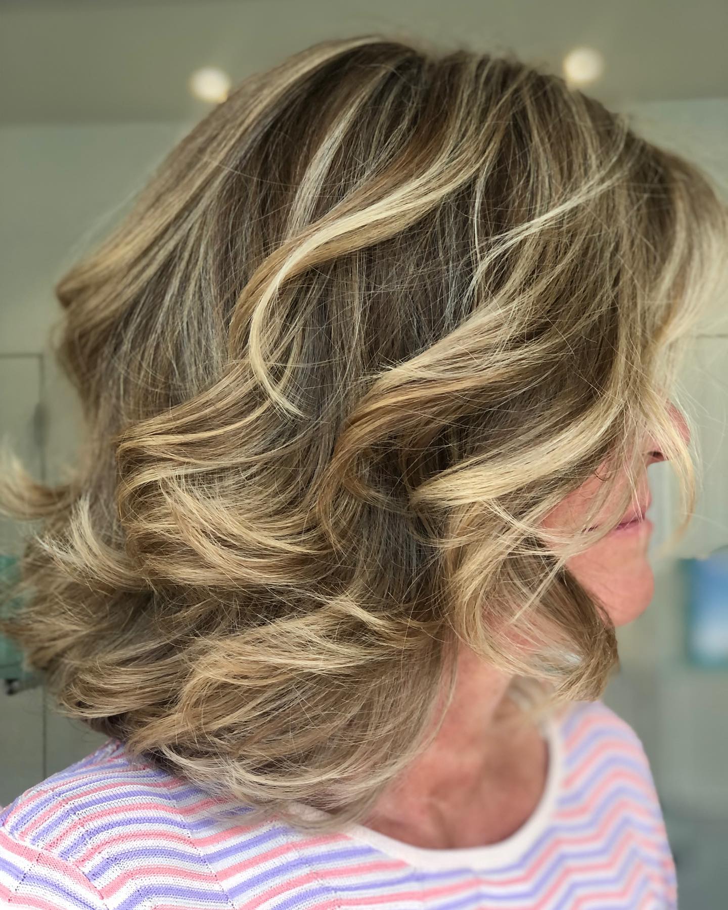 Softly Layered Brunette Curls with Subtle Highlights