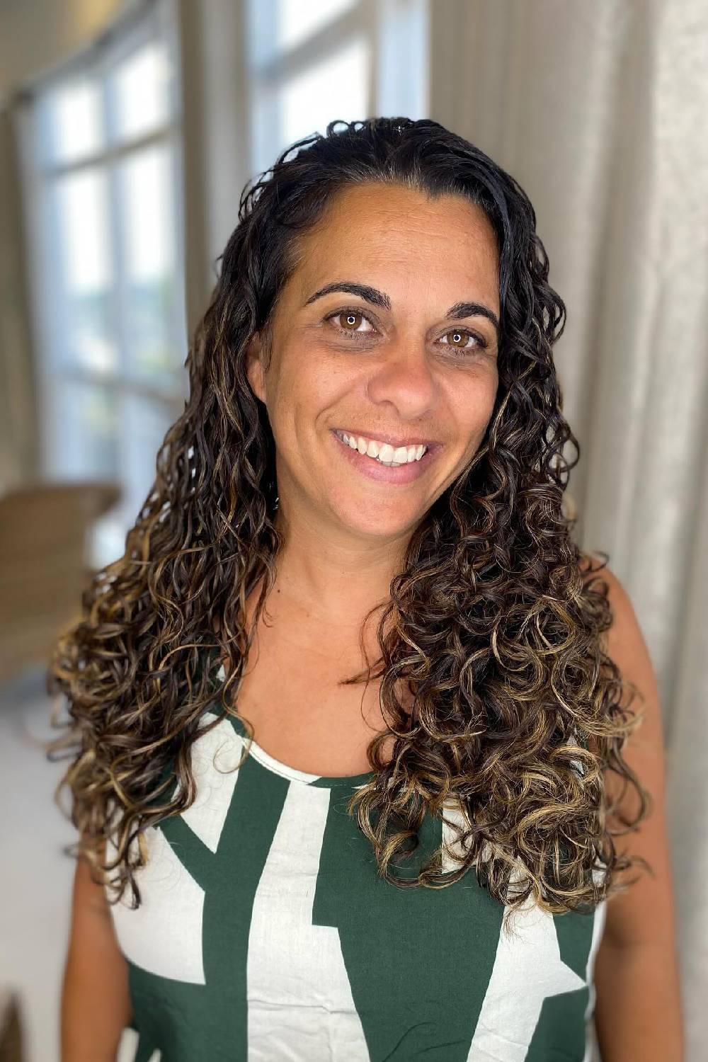 Curly Cascade with Sun-Kissed Highlights