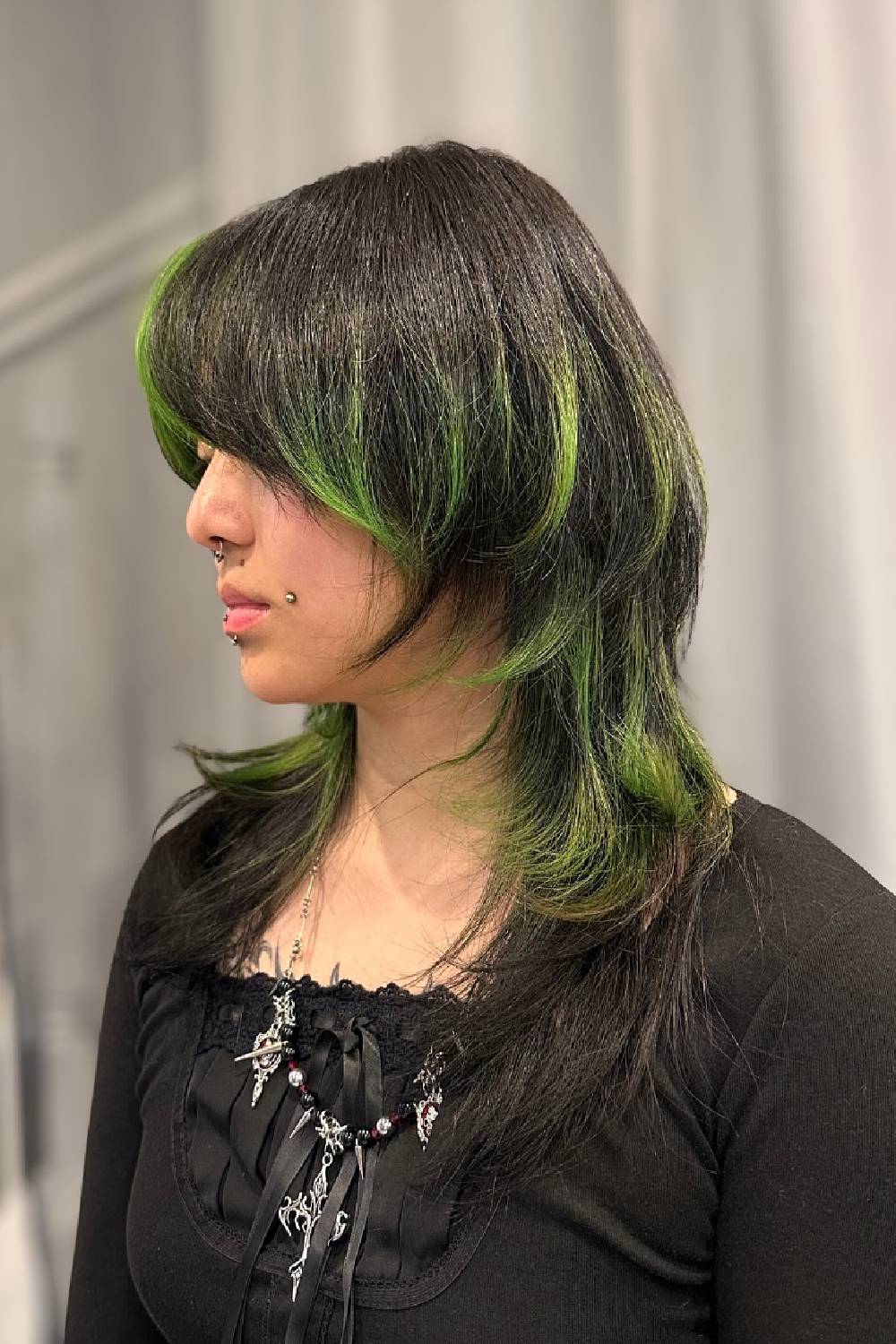 Edgy Layered Cut with Vibrant Green Highlights