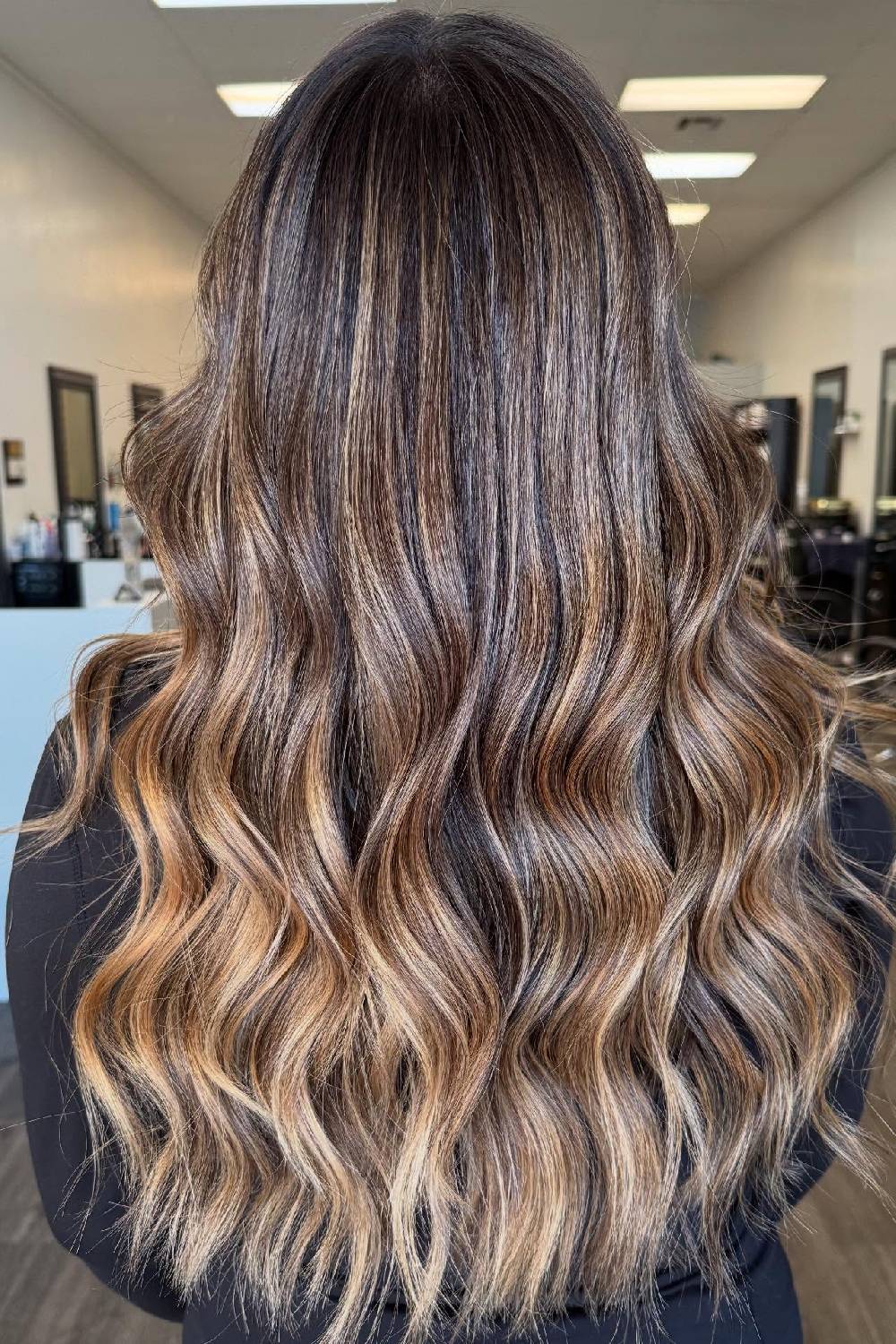 Stylish Long Wavy Layers with Sun-Kissed Highlights