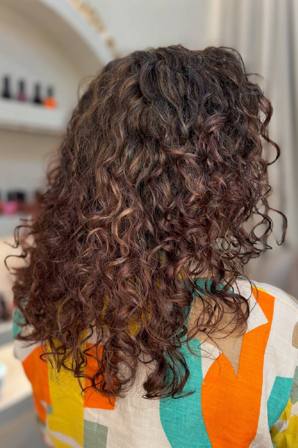 Textured Curly Cut with Subtle Warm Highlights