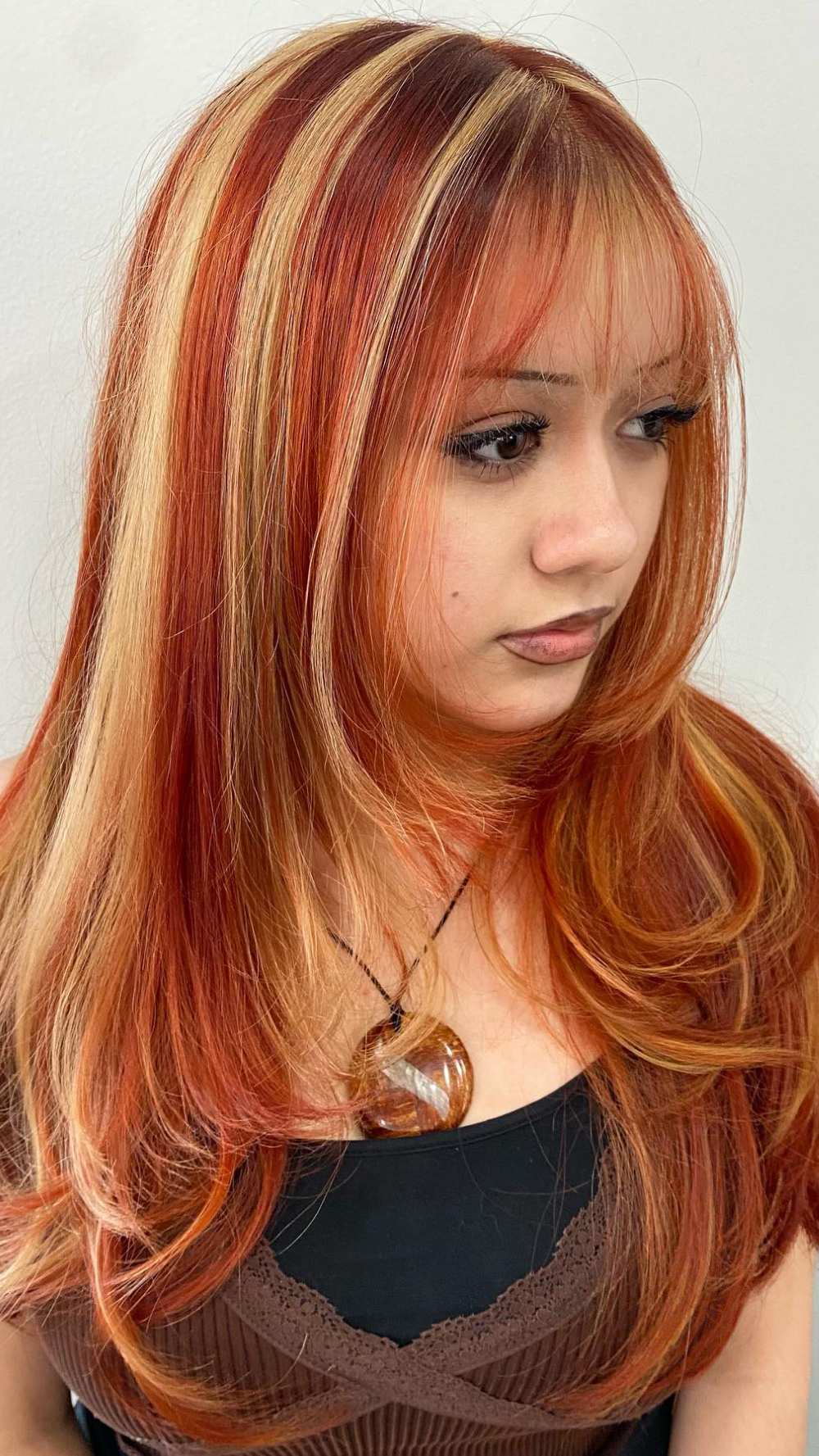 Vibrant Red and Blonde Layered Hair with Bold Highlights