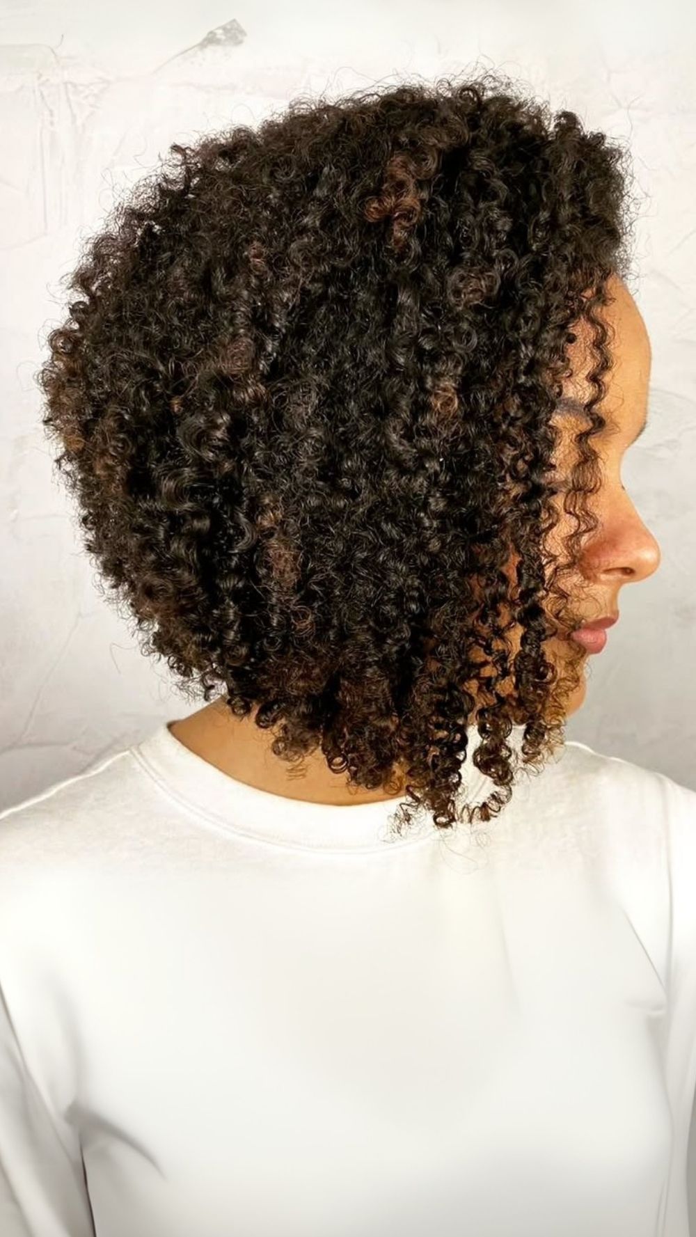 Defined Curly Stacked Bob with Subtle Highlights