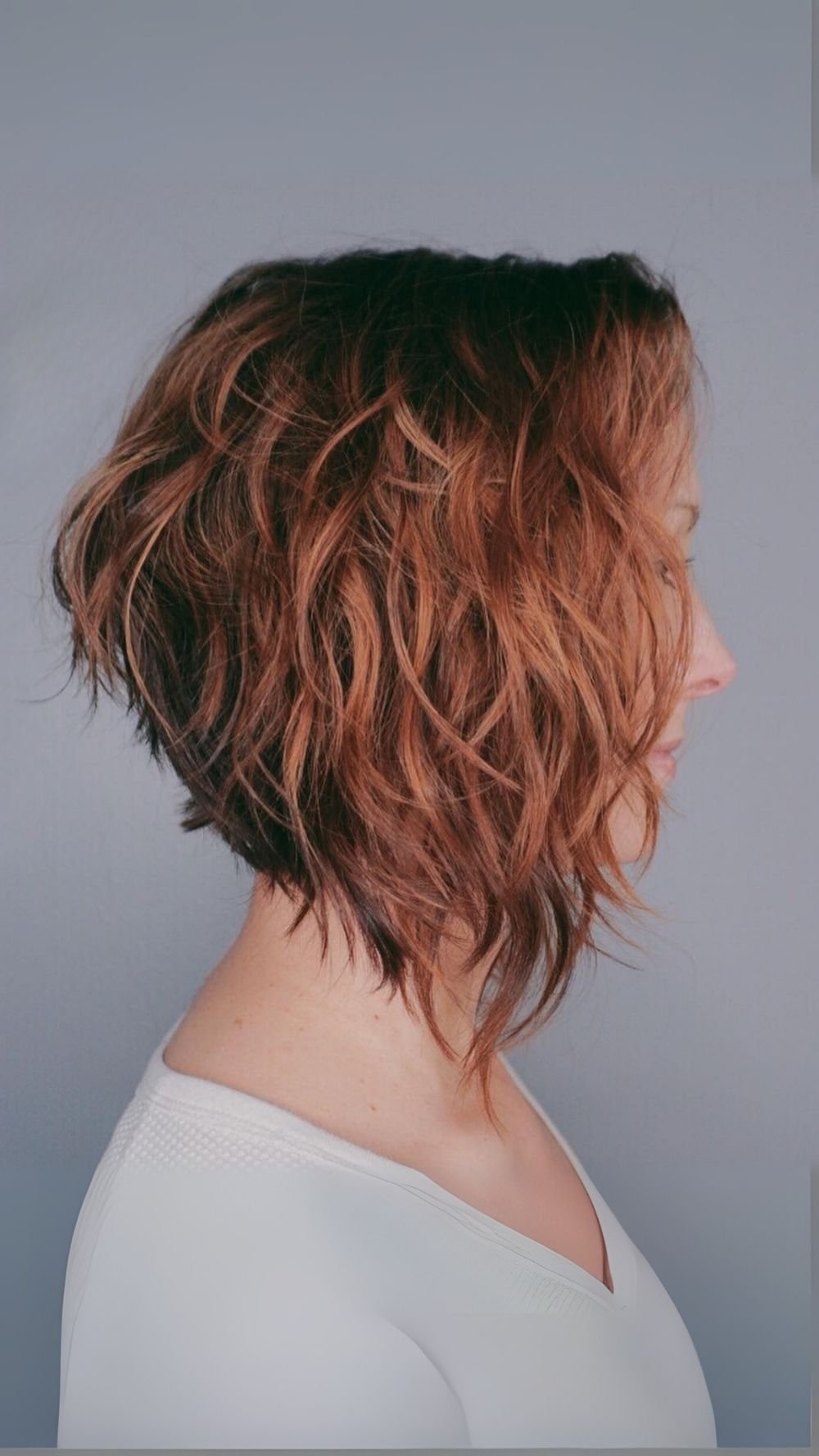 Textured Copper Stacked Curly Bob with Side Swept Bangs