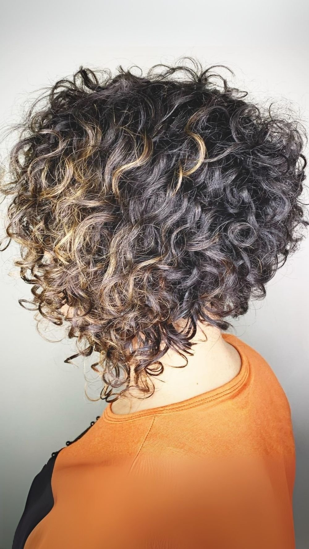 Textured Stacked Curly Bob with Subtle Caramel Highlights