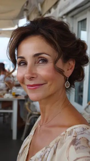 Elegant Soft Curly Updo with Face-Framing Tendrils