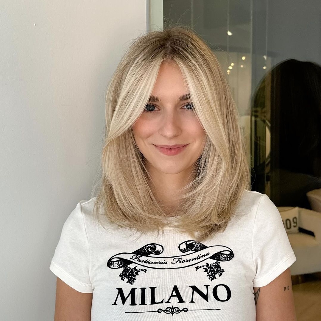 Chic Textured Mid-Length Blonde Cut with Face-Framing Layers