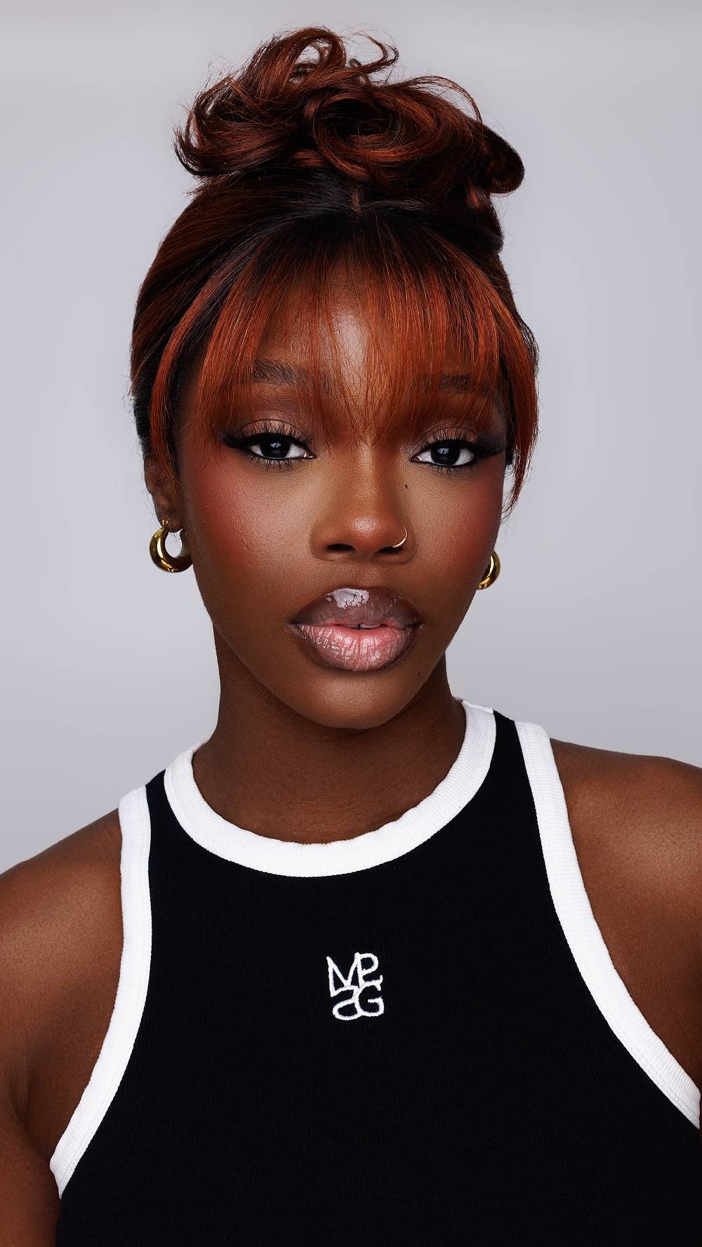 Bold Curly Bangs with Rich Copper Highlights