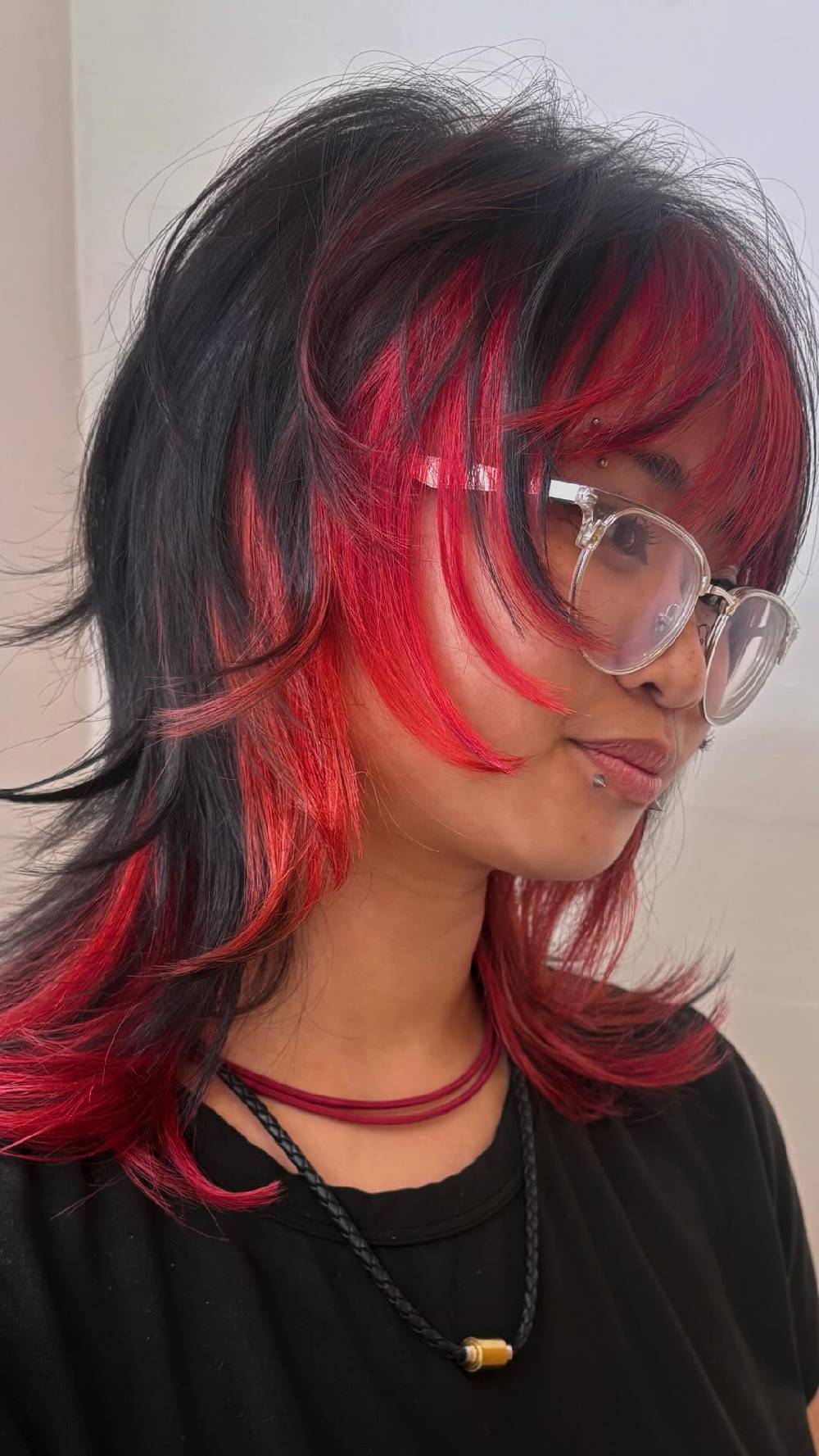 Bold Red and Black Textured Wolfcut with Face-Framing Layers