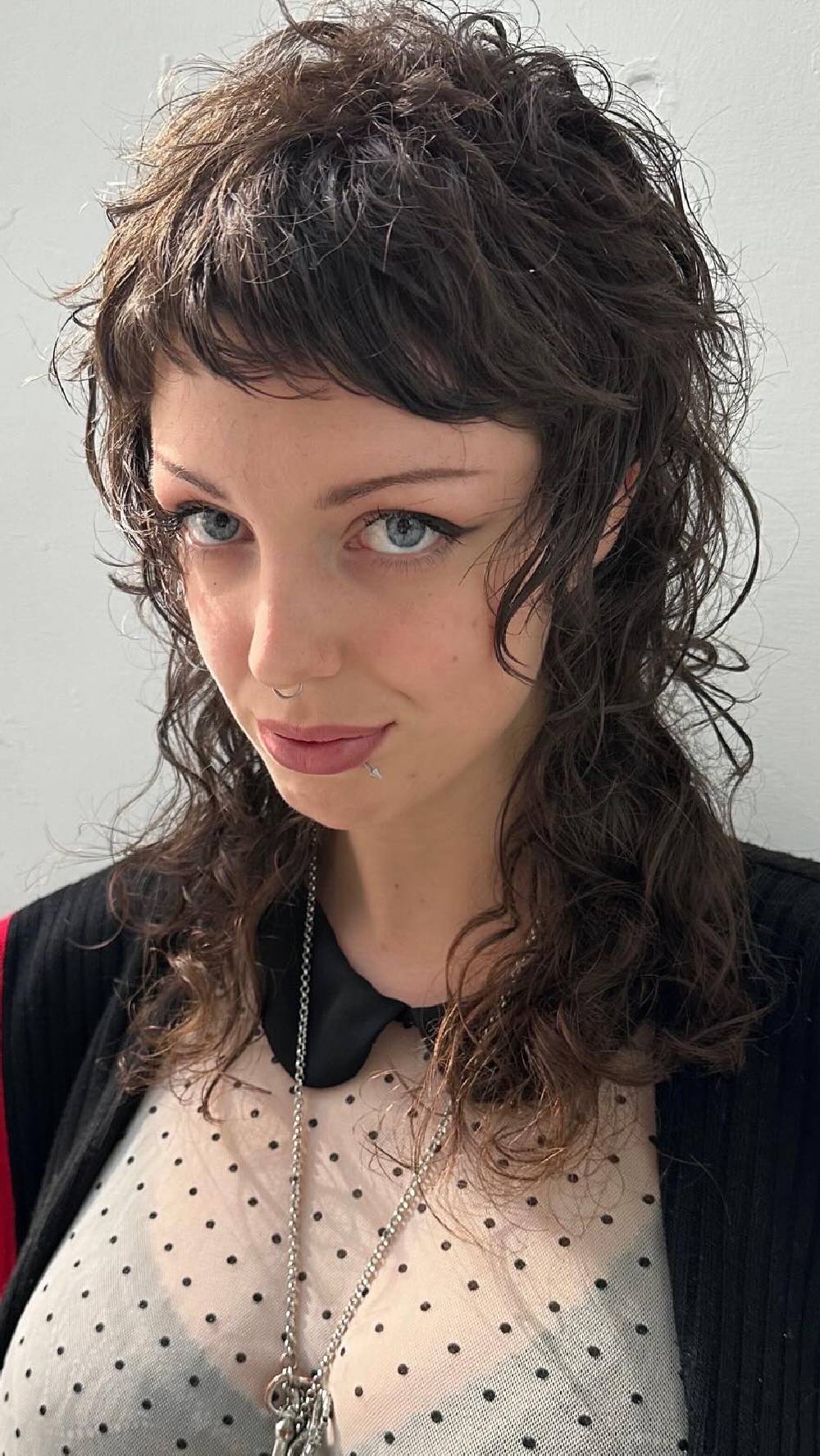 Edgy Curly Wolfcut with Bold Fringe