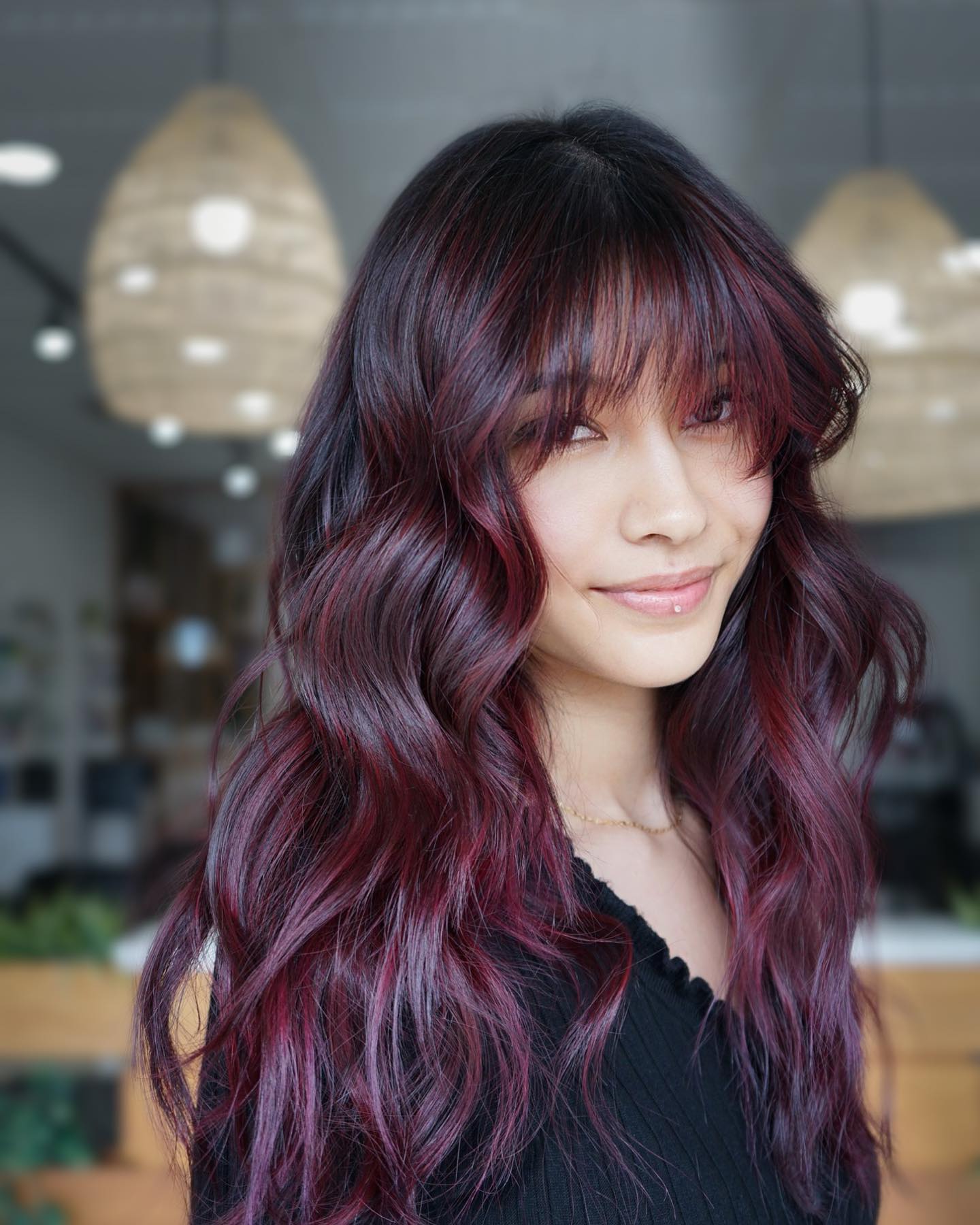 Chic Black Cherry Balayage with Soft Bangs