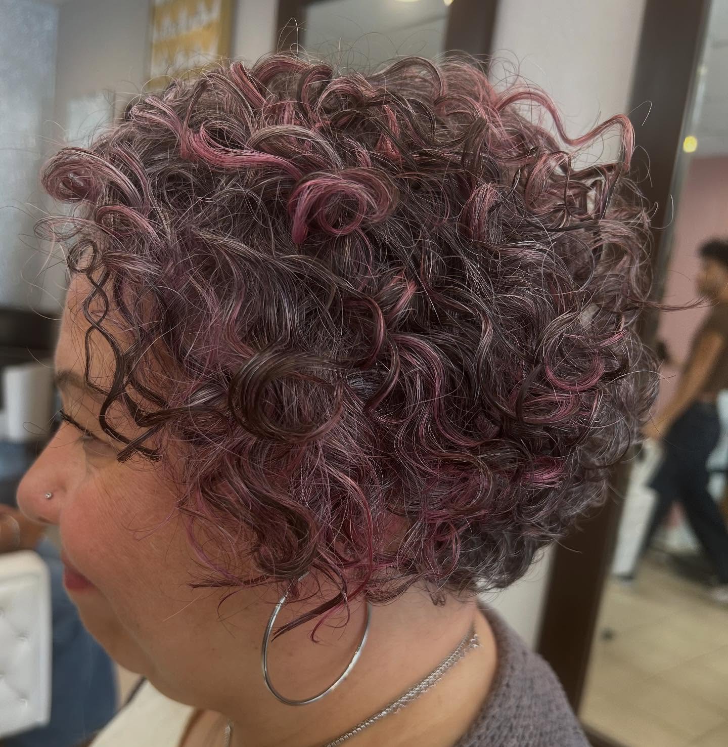 Chic Short Curly Cut with Subtle Pink Highlights
