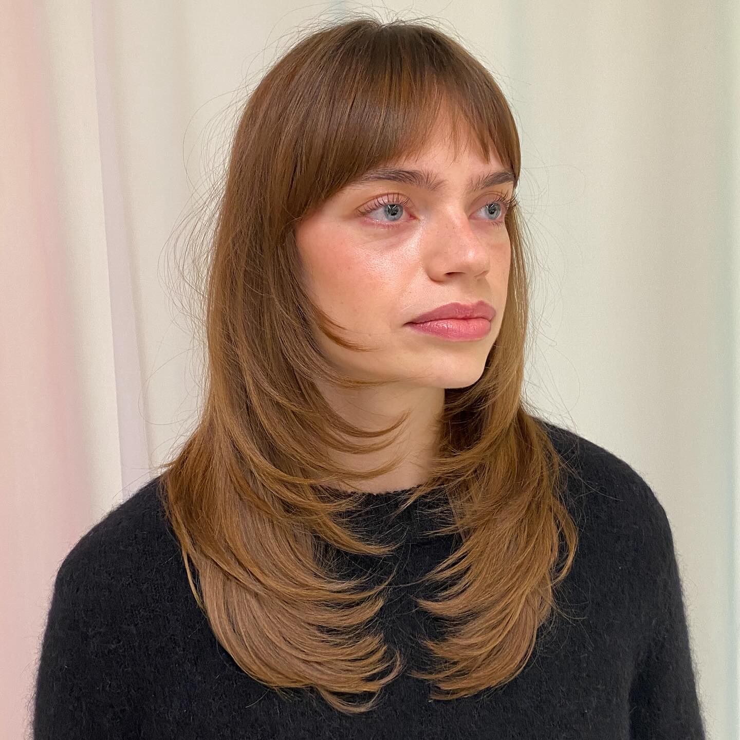 Layered Haircut with Soft Bangs and Face Framing