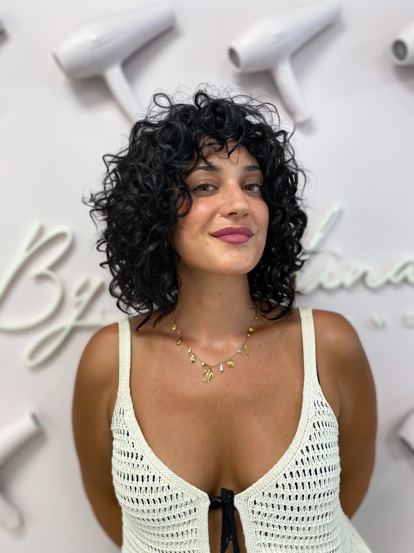 Dynamic Shoulder-Length Black Curls with Subtle Highlights