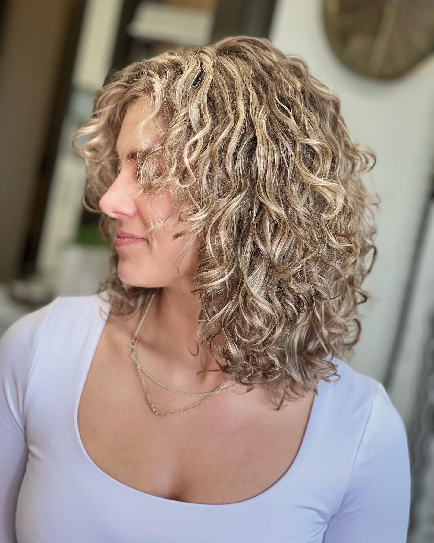 Layered Natural Blonde Curly Bob with Subtle Highlights