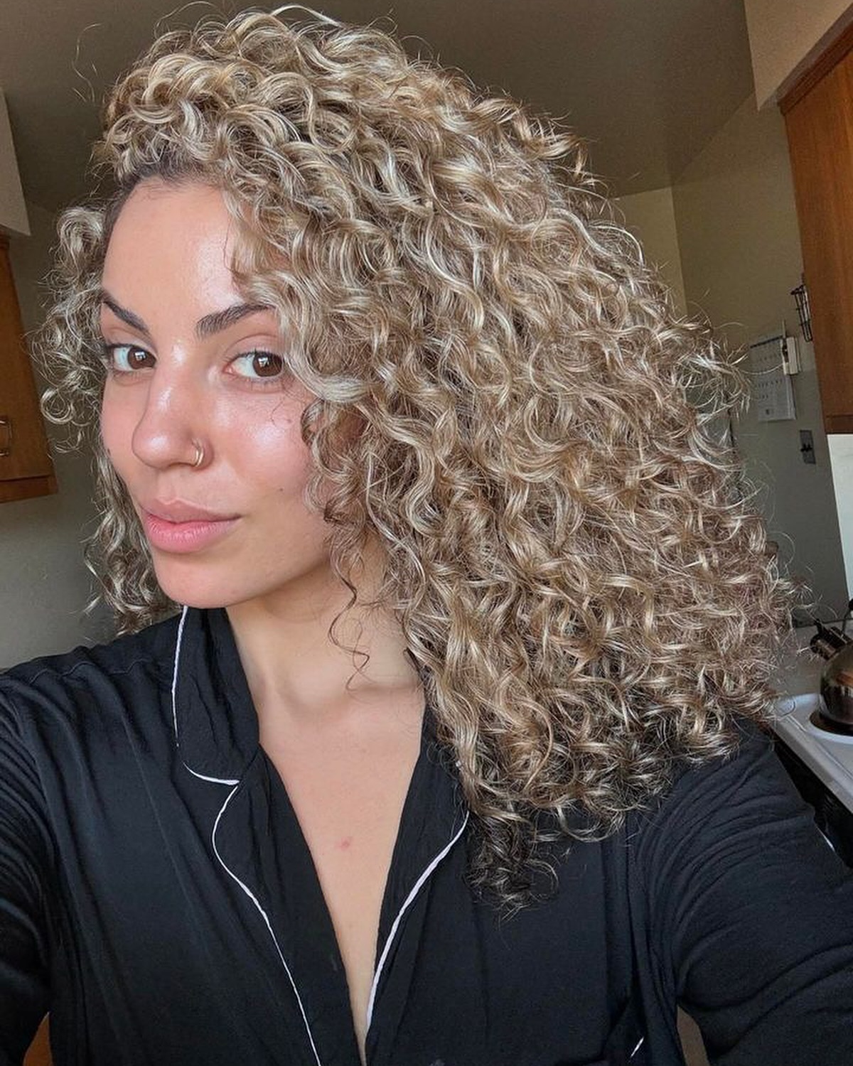 Lush Ash-Blonde Corkscrew Curls with Seamless Layers