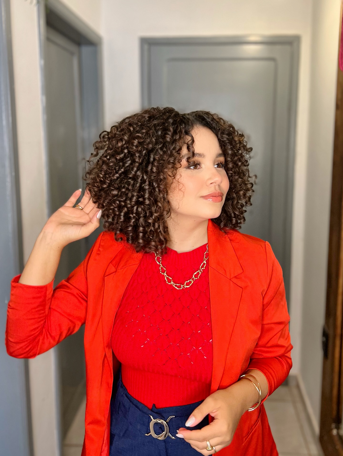 Voluminous Chestnut Curls with Mid-Length Cut