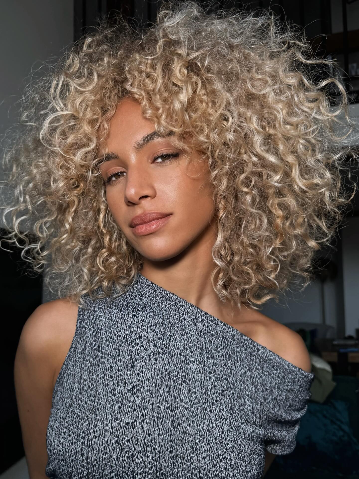 Whimsical Blonde Tousled Curls with Voluminous Roots