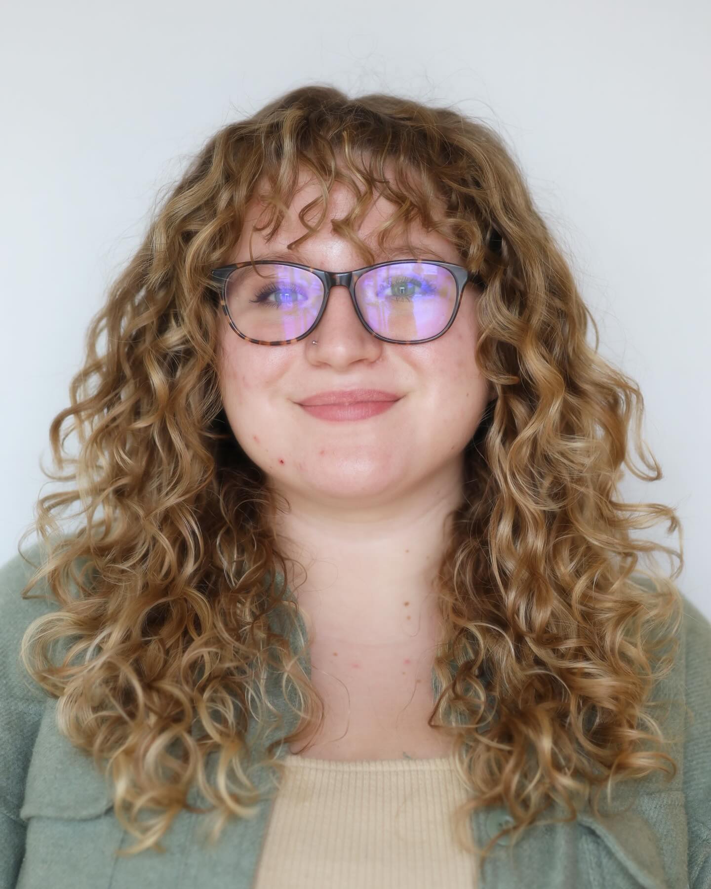 Charming Curly Face-Framing Cut with Soft Bangs