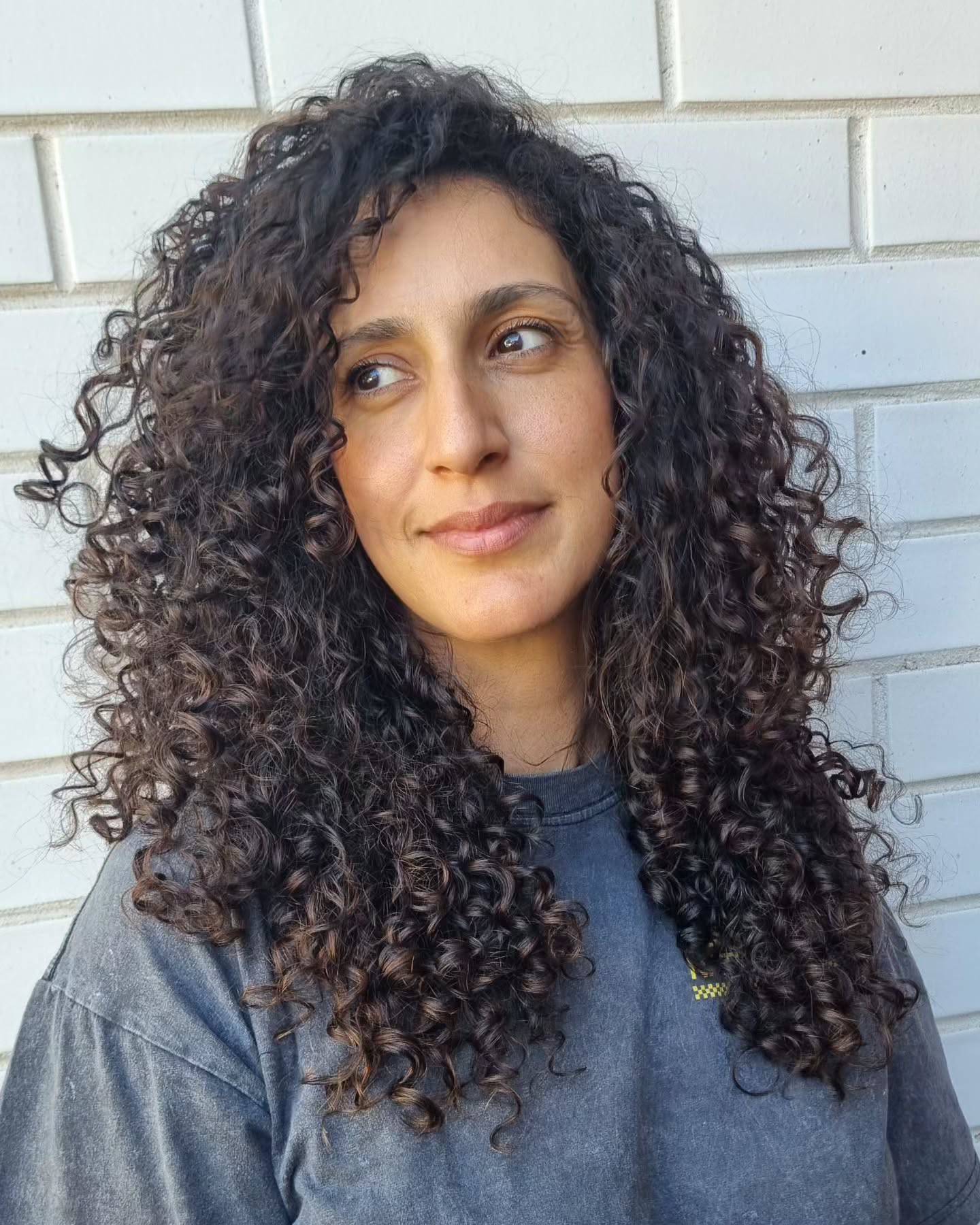 Textured Curly Face-Framing Layers with Soft Volume